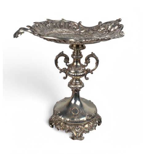 187 - A mixed lotTo include:[a] Turkish (?), white metal/silver (?) tazza[b] A silver ribbon and floral re... 