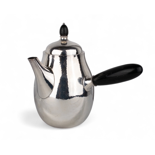 194 - Georg Jensen, Denmark, Circa 1960A sterling silver planished coffee pot with ebony handle. Hallmarke... 