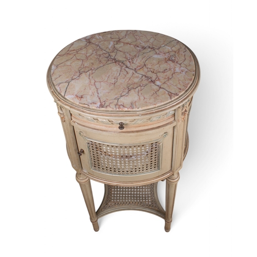 253 - Louis XV styleA hand-painted bedside table with marble topOn fluted legs, with wicker to the side an... 