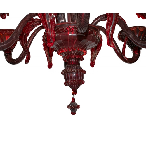 262 - 20th century, MuranoA red chandelier with floral inserts and six wired lightsTogether with an extra ... 