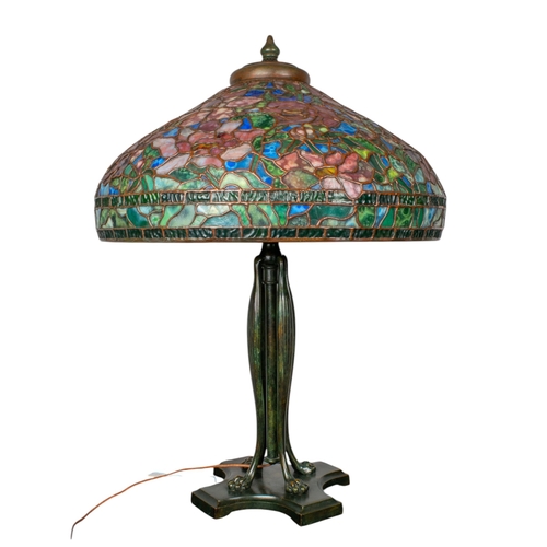 265 - A large Tiffany style stained glass lampWith floral design and four lion paw feetProperty of a noble... 