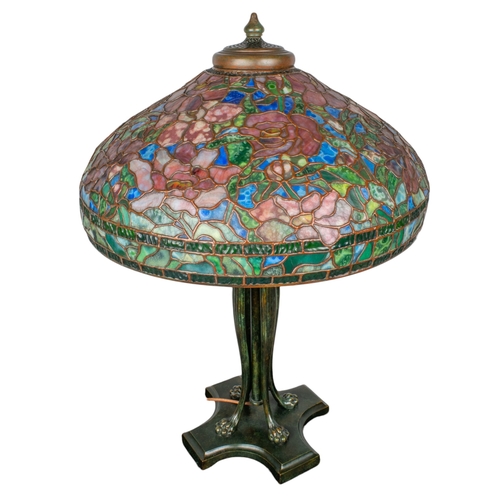 265 - A large Tiffany style stained glass lampWith floral design and four lion paw feetProperty of a noble... 