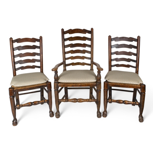 282 - AntiqueA set of six ladder back dining chairs including two carvers, all with rush seatsTo be sold w... 