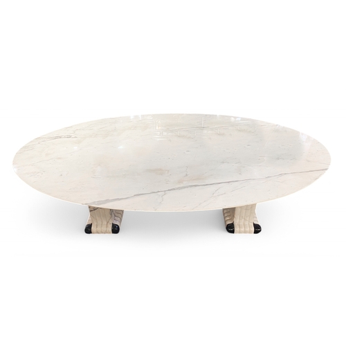 284 - ContemporaryA large oval marble table on two fluted black and white marble columnsTo be sold without... 