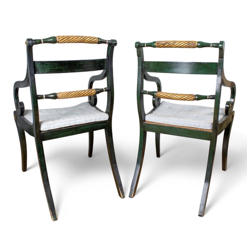 300 - RegencyA pair of painted and gilded elbow chairsThe backs with a centre rail applied with brass moti... 