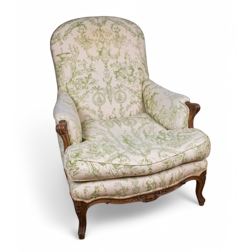 307 - A beech framed armchair in the French tasteUpholstered in green printed toileWith everted scroll arm... 