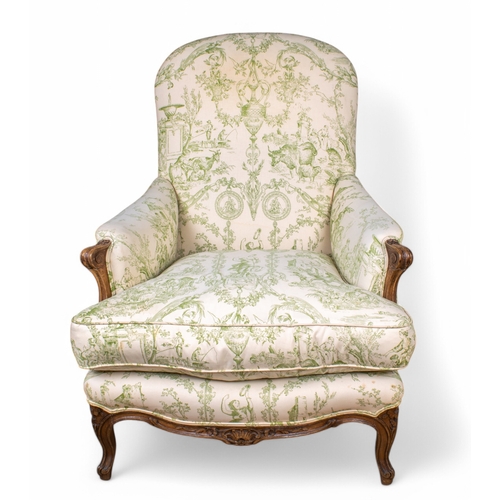 307 - A beech framed armchair in the French tasteUpholstered in green printed toileWith everted scroll arm... 