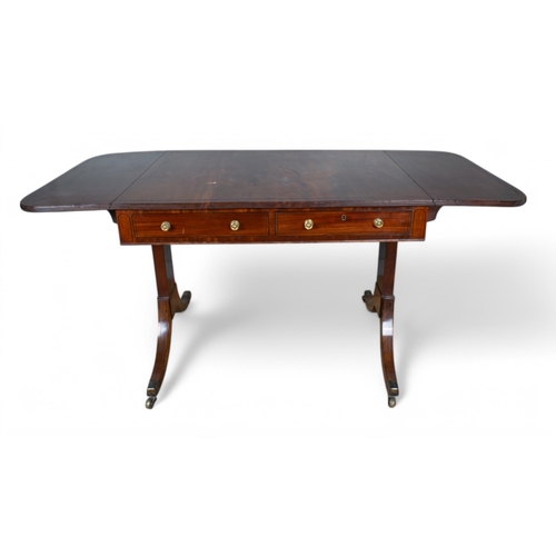 315 - RegencyA mahogany sofa table inlayed with ebonised linesThe rectangular top with hinged sidesAlterna... 