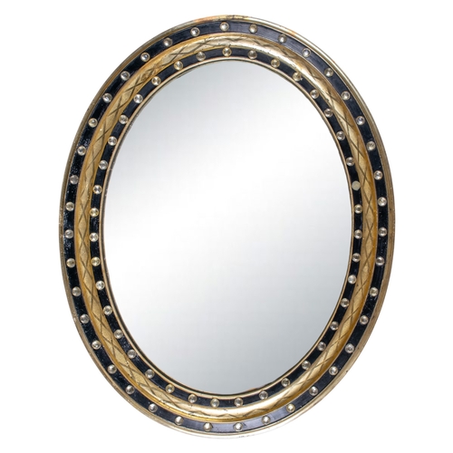 316 - IrishGeorgianAn oval wall mirrorThe ebonies and gilded frame studded with glass beadsFrom the Fane C... 