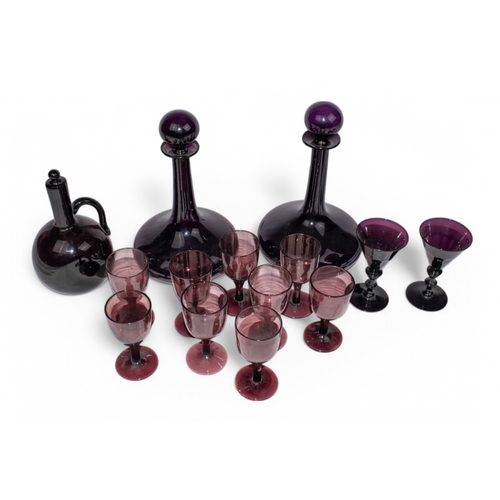 344 - AntiqueA collection of amethyst glass, to include:[a] A pair of ships decanters with globe stoppers[... 