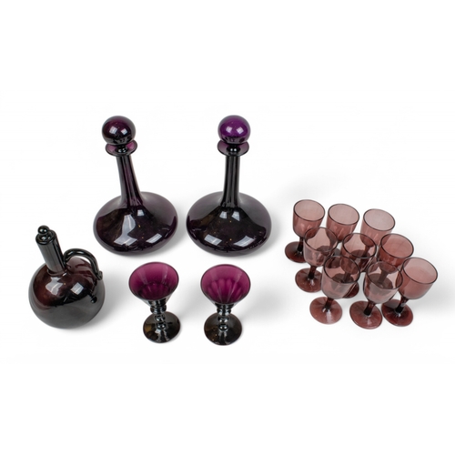 344 - AntiqueA collection of amethyst glass, to include:[a] A pair of ships decanters with globe stoppers[... 