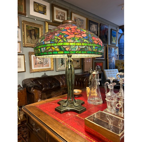 265 - A large Tiffany style stained glass lampWith floral design and four lion paw feetProperty of a noble... 