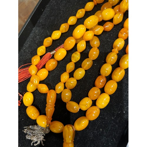 91 - A group of three butterscotch amber prayer bead necklacesProperty of a noblemanTotal weight: Approx.... 