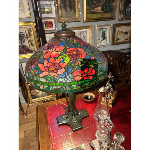 265 - A large Tiffany style stained glass lampWith floral design and four lion paw feetProperty of a noble... 