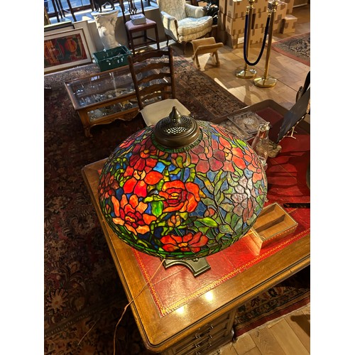 265 - A large Tiffany style stained glass lampWith floral design and four lion paw feetProperty of a noble... 