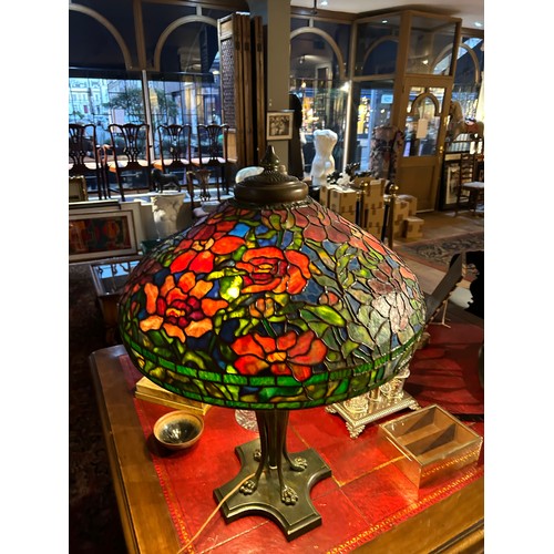 265 - A large Tiffany style stained glass lampWith floral design and four lion paw feetProperty of a noble... 