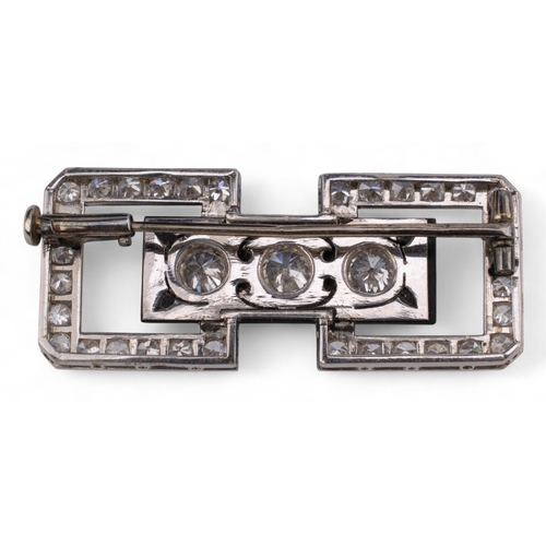 86 - Art DecoA diamond and onyx platinum plaque brooch, or architectural form, set to the centre with thr... 
