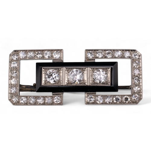 86 - Art DecoA diamond and onyx platinum plaque brooch, or architectural form, set to the centre with thr... 