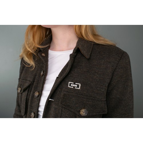 86 - Art DecoA diamond and onyx platinum plaque brooch, or architectural form, set to the centre with thr... 