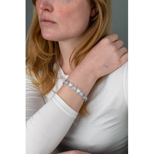 111 - Continental, ContemporaryAn 18k white gold diamond heart-shaped sectioned bracelet, composed of seve... 