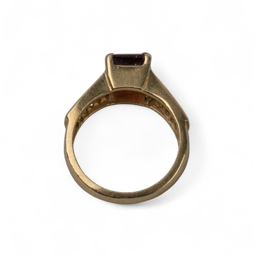 22 - A red tourmaline and diamond 14k gold ring, circa 1980The rectangular-cut red tourmaline with three-... 
