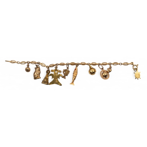 23 - A yellow gold charm bracelet, circa 1940sThe oval bar-link bracelet applied with ten various charms,... 