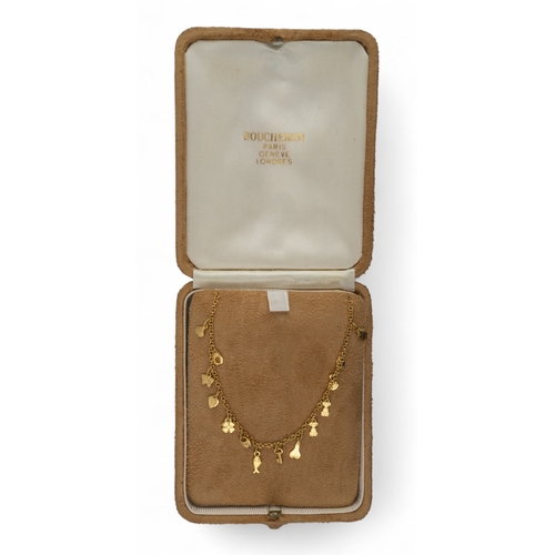 32 - A pretty 18k gold charm necklaceThe oval chain set with fourteen charms, including a key, a heart, a... 