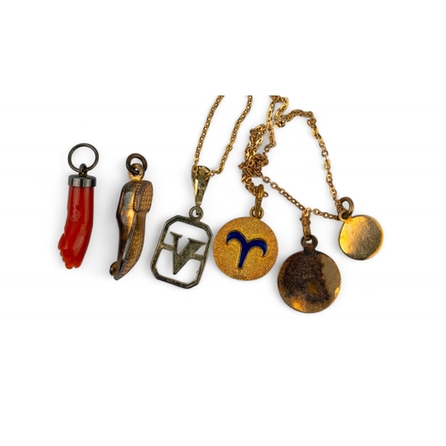 39 - To include:[a]&nbsp;Antique, A carved coral hand pendant[b] A yellow gold Oriental slipper charm[c] ... 
