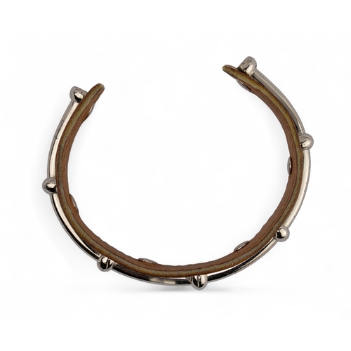 51 - Herm&egrave;s, A silver metal and leather Agatha bangleSignedTo be sold without reserve... 