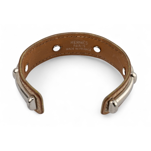 51 - Herm&egrave;s, A silver metal and leather Agatha bangleSignedTo be sold without reserve... 