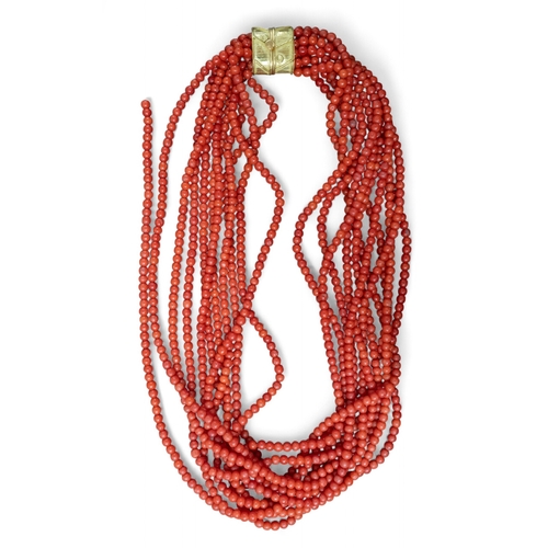 56 - An eleven-row uniform sized red coral torsade necklace, circa 1980s.Set to an 18k gold claspTotal le... 