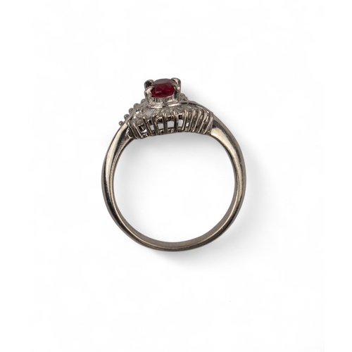 60 - A pretty ruby and diamond cluster ringThe oval-shaped ruby weighing 0.51 cts. Within a surround of b... 