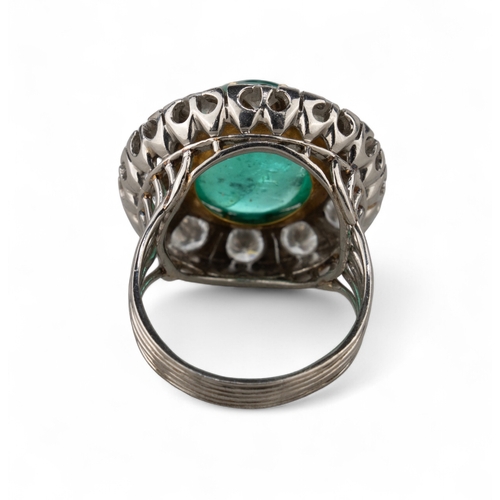 88 - A striking cabochon emerald and diamond cluster ring, circa 1950The central ovoid-shaped cabochon em... 