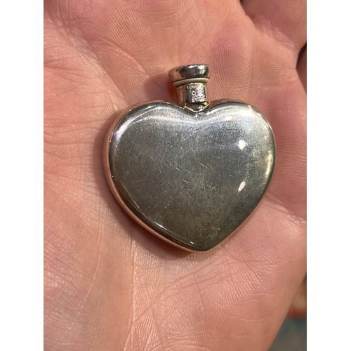 35 - Tiffany & Co, A silver heart-shaped scent bottle and funnelIn its original box and pouch.Approx.... 