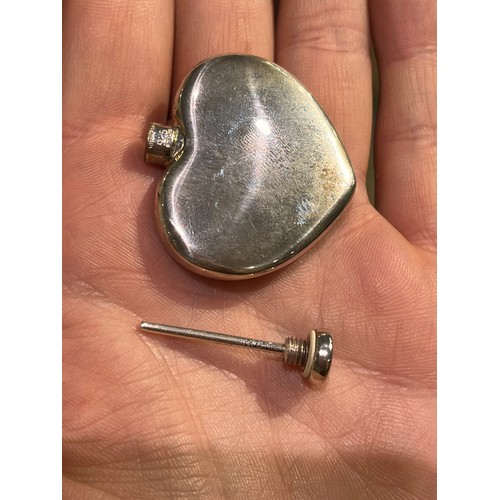 35 - Tiffany & Co, A silver heart-shaped scent bottle and funnelIn its original box and pouch.Approx.... 