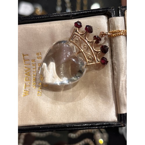59 - Antique, A heart-shoved rock crystal, gold and garnet pendant, circa 1890.The polished rock crystal ... 