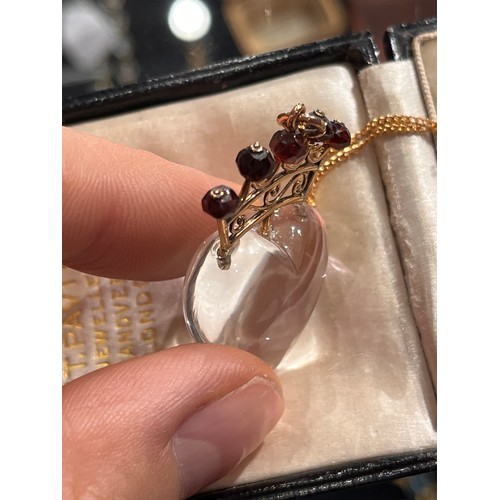 59 - Antique, A heart-shoved rock crystal, gold and garnet pendant, circa 1890.The polished rock crystal ... 