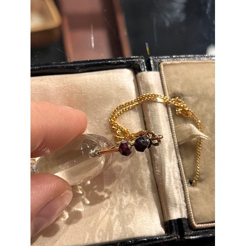 59 - Antique, A heart-shoved rock crystal, gold and garnet pendant, circa 1890.The polished rock crystal ... 