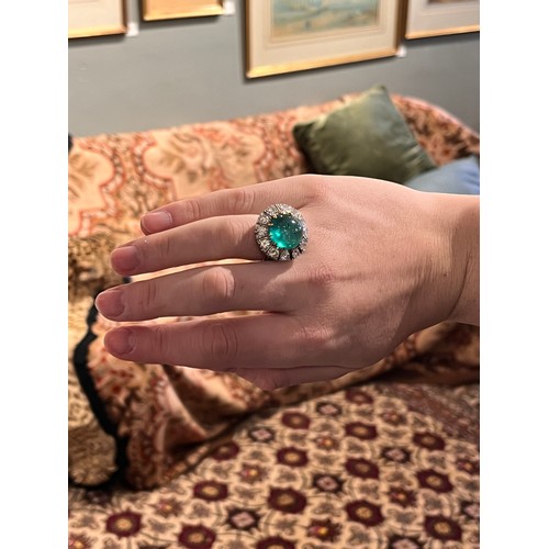 88 - A striking cabochon emerald and diamond cluster ring, circa 1950The central ovoid-shaped cabochon em... 