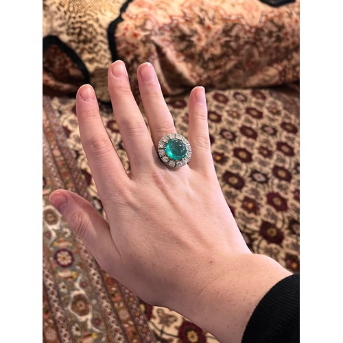 88 - A striking cabochon emerald and diamond cluster ring, circa 1950The central ovoid-shaped cabochon em... 