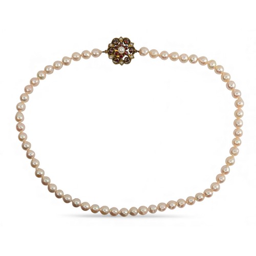 9 - A cultured pearl necklace, circa 1950Composed of a uniform row of 7 mm. slightly baroque cultured pe... 