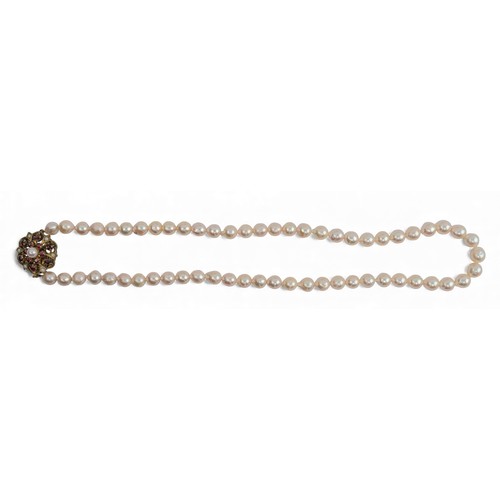 9 - A cultured pearl necklace, circa 1950Composed of a uniform row of 7 mm. slightly baroque cultured pe... 