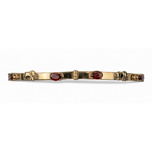 13 - Circa 1970 A 9 carat gold and garnet elephant motif bangleWeight: Approx. 12.88 gramsDimensions: 7.2... 