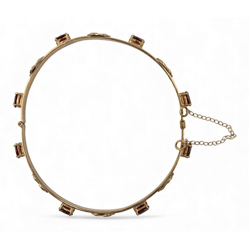 13 - Circa 1970 A 9 carat gold and garnet elephant motif bangleWeight: Approx. 12.88 gramsDimensions: 7.2... 