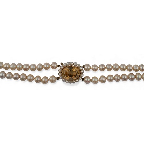24 - A two-row cultured pearl necklace with citrine and pearl claspThe two rows of slightly baroque unifo... 