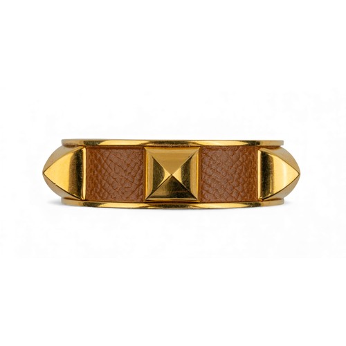 35 - Hermès, ParisA leather and gilt metal bangle, circa 1980Signed.