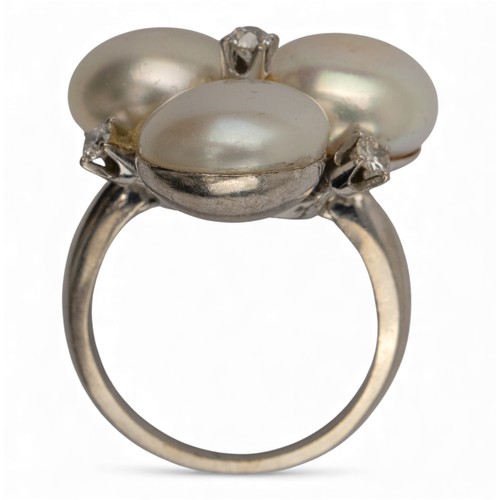 47 - Circa 1950sA trefoil bouton shaped cultured pearl and four stone diamond cluster ringWeight: Approx.... 