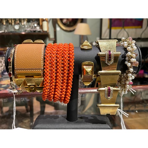 45 - Circa 1980A gold and multi-gem set braceletSet with various melon fluted gems, and a fringe of small... 