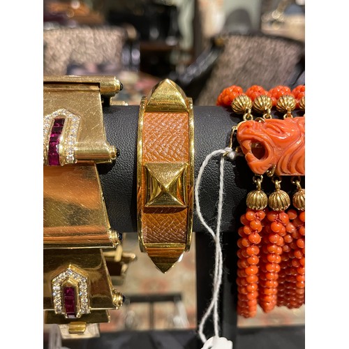 35 - Hermès, ParisA leather and gilt metal bangle, circa 1980Signed.