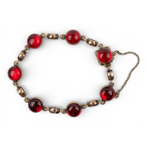 3 - AntiqueA 9k gold and cabochon red paste bracelet. Composed of seven circular rub-over mounted stones... 